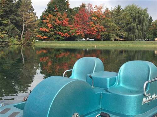 A paddle boat in the lake at COOPERSTOWN SHADOW BROOK CAMPGROUND