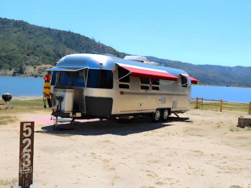 An RV parked in a lakefront site