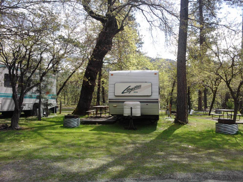 Trailer at grassy site at Antlers Resort & RV Park