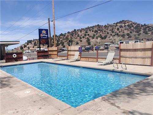 The fenced in swimming pool at CEDAR CITY RV RESORT BY RJOURNEY