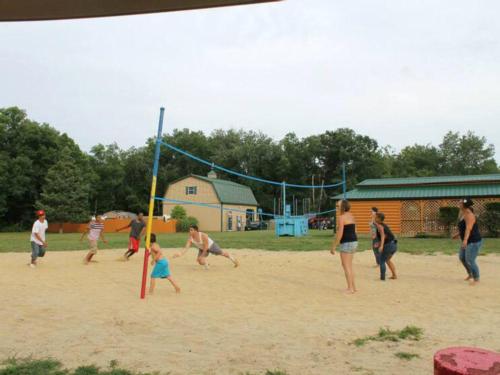 Group of people playing sand volleyball at BUTTERFLY CAMPING RESORT