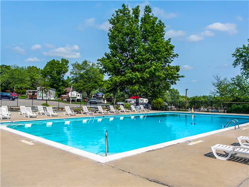 Pool area with lounge chairs at ROUND TOP CAMPGROUND