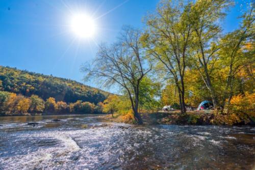 Lake view with fall trees at Kittatinny River Beach Campground