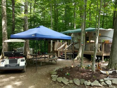 RV parked with patio attached at Lakeside Campground