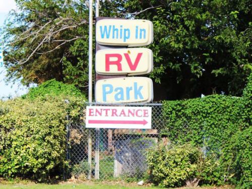 Campground signs near entrance at WHIP IN RV PARK