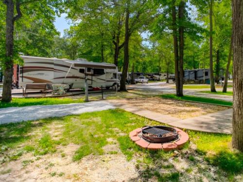Open RV space with fire pit at The Broken Banjo RV Park