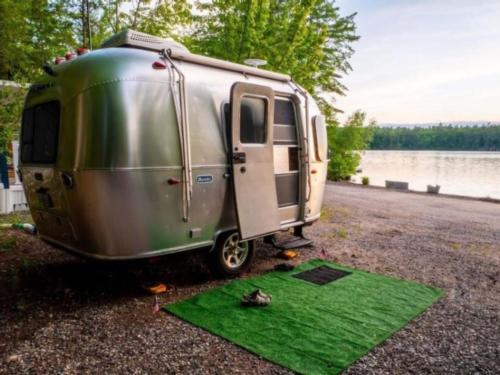 Airstream in waterfront site at Loon's Haven Family Campground