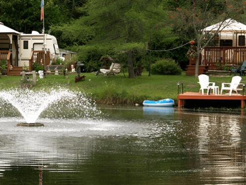 A dock with chairs and RVs in the background
