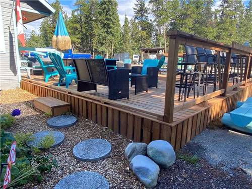 Raised wooden patio with chairs at CARIBOU RV PARK