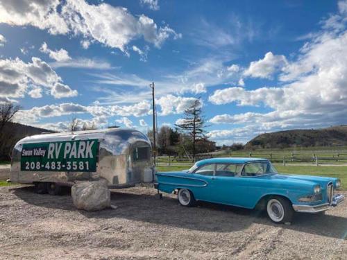 Park name on an Airstream hitched to an old style car at SWAN VALLEY RV PARK