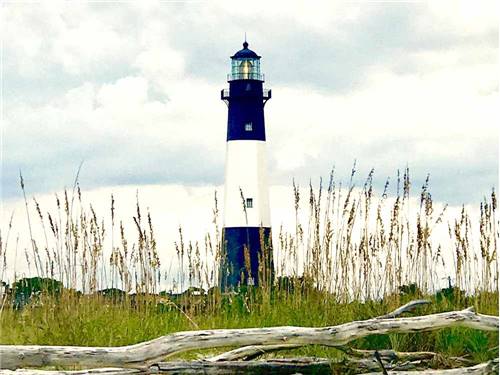 A blue and white lighthouse nearby at RIVER'S END CAMPGROUND