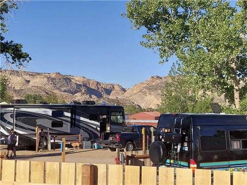RVs parked with mountains in the distance at CANYONS OF ESCALANTE RV PARK