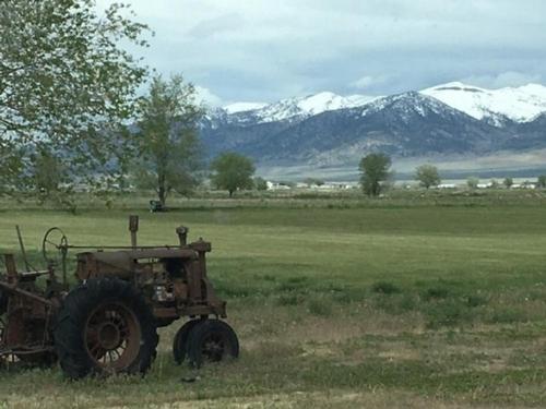 Antique tractor by mountains at The Hitching Post RV Park