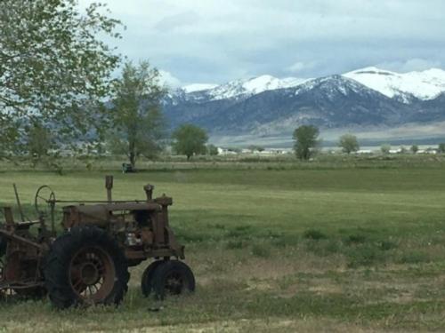 Antique tractor by mountains at The Hitching Post RV Park