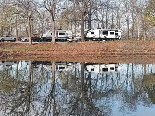 Reflection of RVs in the water at Arrowhead Point RV Park & Campground