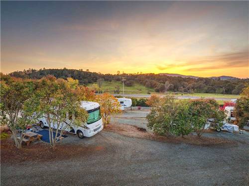 Big rig parked in a gravel site at ANGELS CAMP RV RESORT