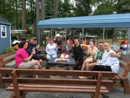 Group of people eating ice cream around a fire pit at Royal Mountain Campground